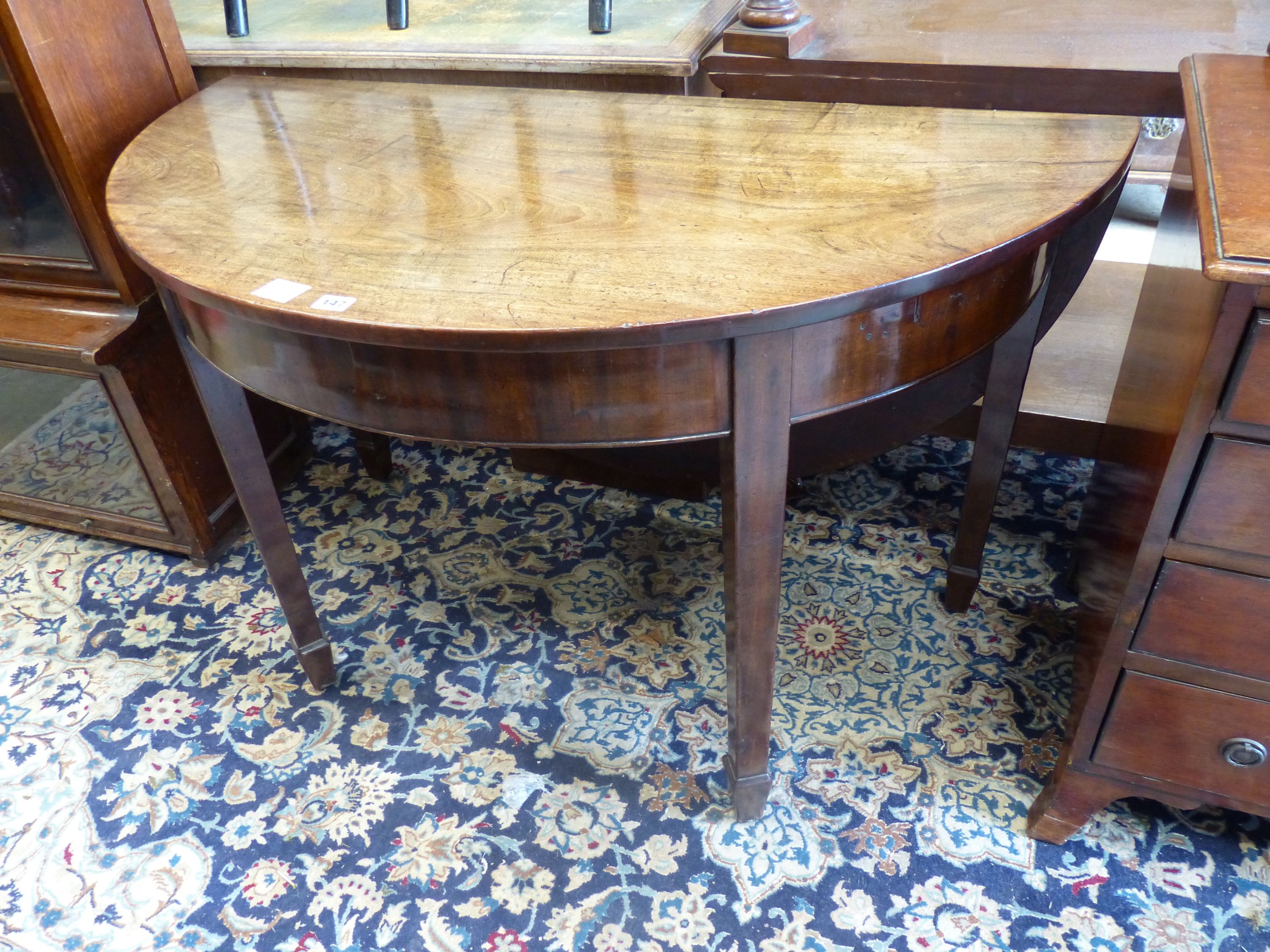 A George III mahogany demi lune drop flap dining table, length 116cm extended, width 118cm, height 71cm